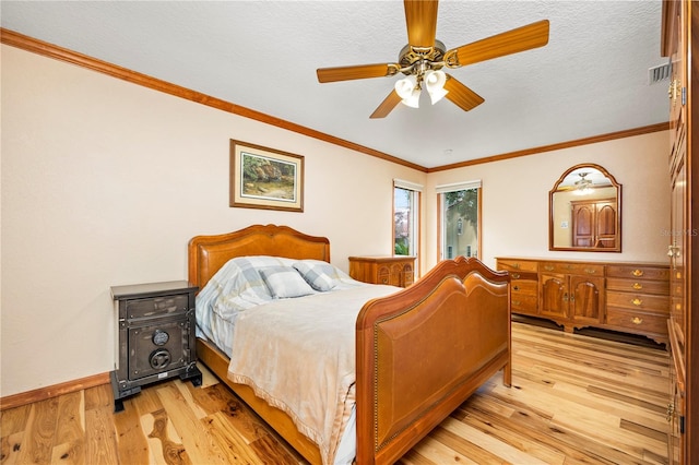 bedroom featuring ornamental molding, a textured ceiling, ceiling fan, and light wood-type flooring