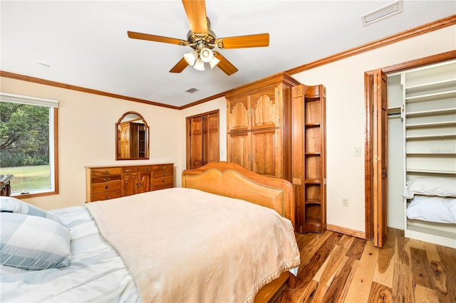 bedroom with ceiling fan, hardwood / wood-style flooring, and ornamental molding