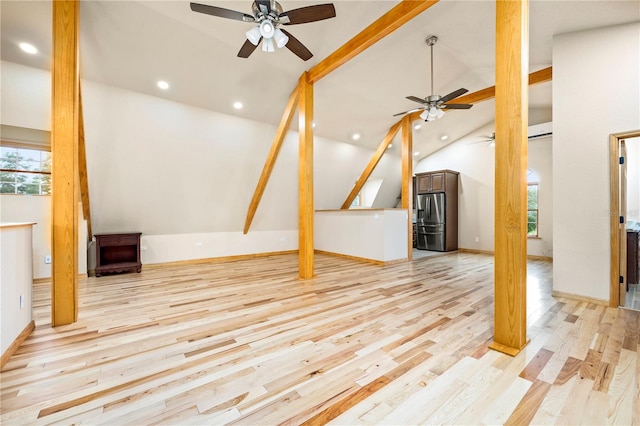 unfurnished living room with light hardwood / wood-style flooring, ceiling fan, and a wealth of natural light