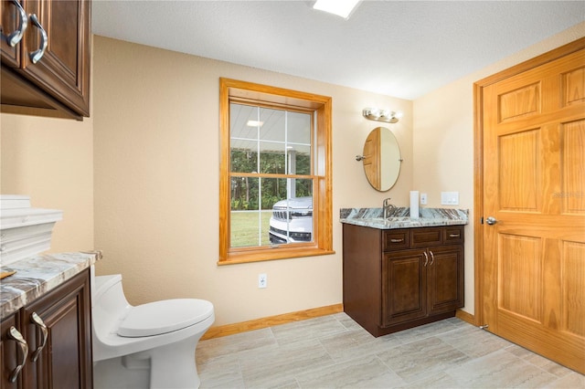 bathroom featuring vanity, tile flooring, and toilet