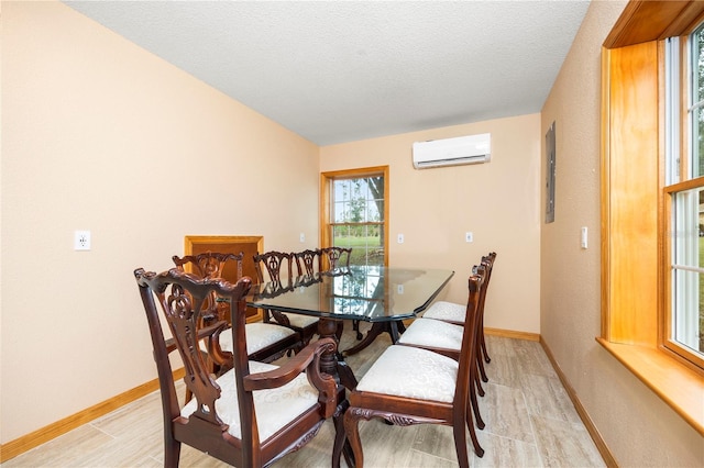 dining room featuring a wall mounted AC and a textured ceiling