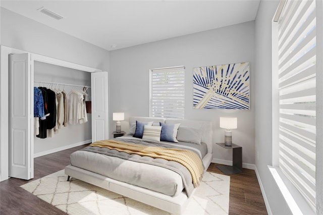 bedroom featuring hardwood / wood-style floors and a closet