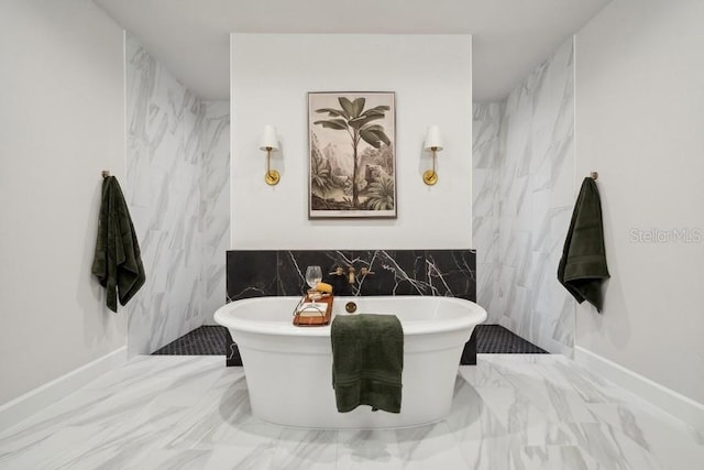 bathroom featuring tile walls and a washtub