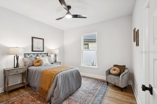 bedroom with ceiling fan and wood-type flooring