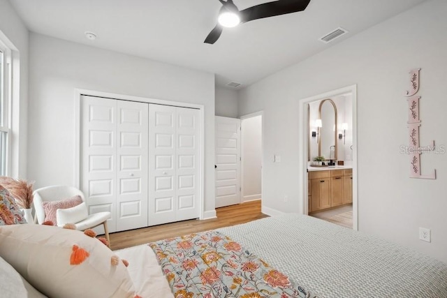 bedroom with connected bathroom, a closet, ceiling fan, and light hardwood / wood-style floors