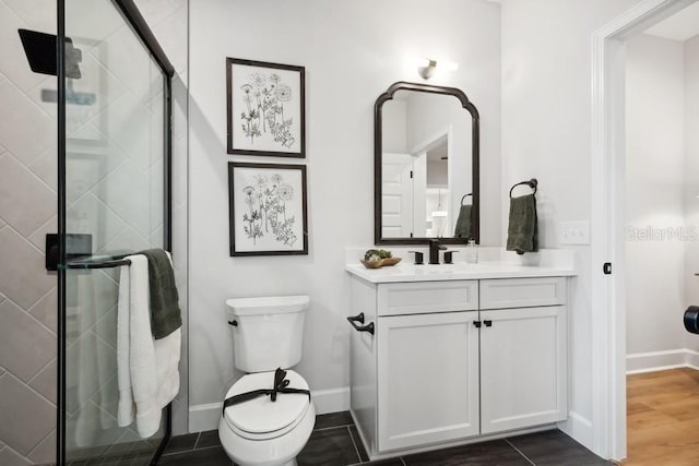 bathroom with toilet, a shower with door, vanity, and tile patterned floors