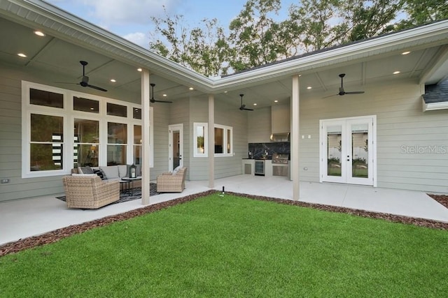 exterior space featuring an outdoor kitchen, a patio, and ceiling fan