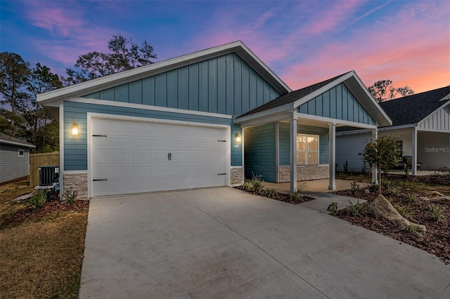 craftsman house with central AC unit and a garage