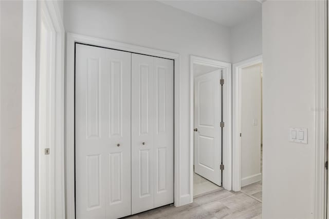 unfurnished bedroom with a closet and light hardwood / wood-style flooring