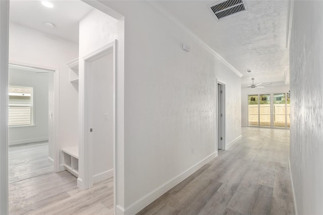 hall featuring ornamental molding and light wood-type flooring