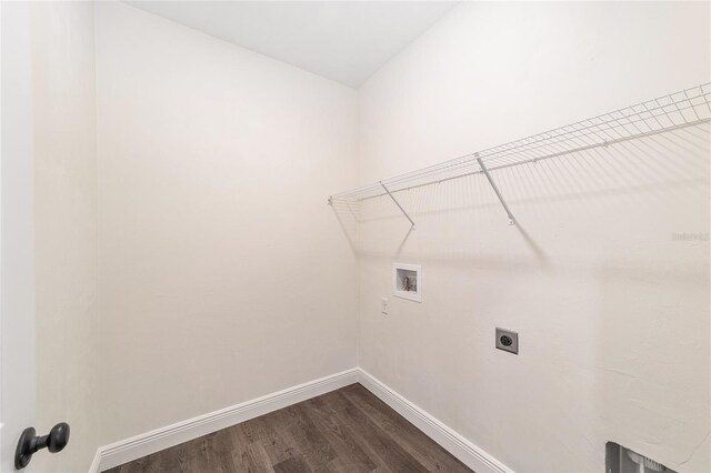 clothes washing area with hookup for a washing machine, hookup for an electric dryer, and wood-type flooring