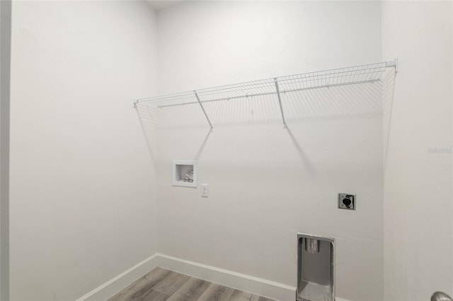 washroom featuring hookup for an electric dryer, hardwood / wood-style flooring, and hookup for a washing machine