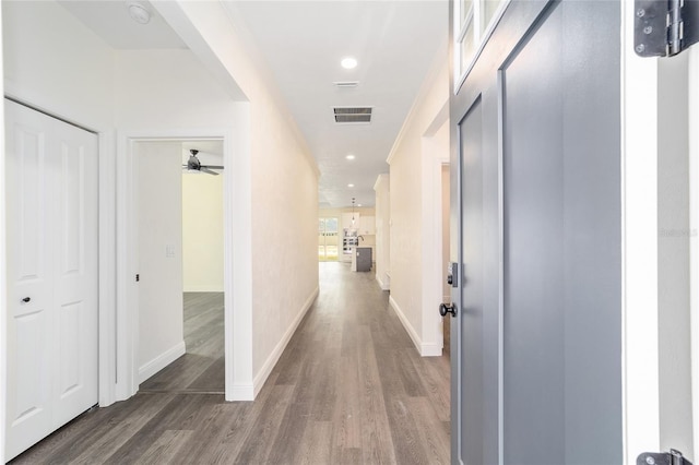 hall with crown molding and dark hardwood / wood-style floors