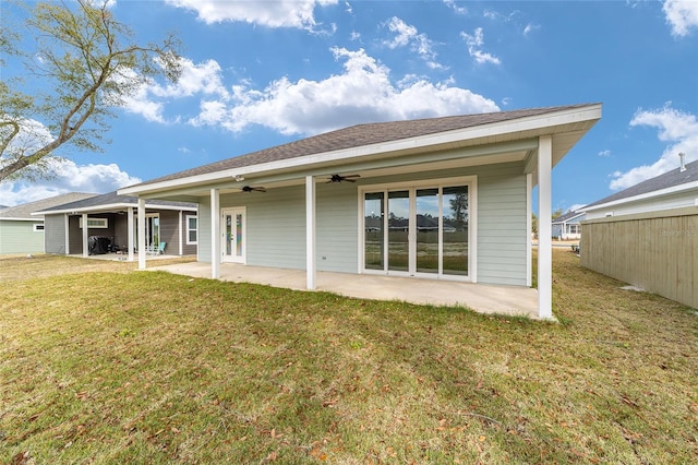 rear view of house with a lawn, a patio, and ceiling fan