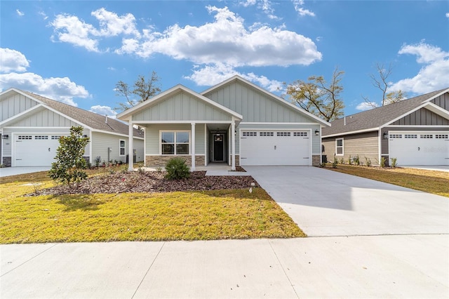 craftsman-style home with a front yard and a garage