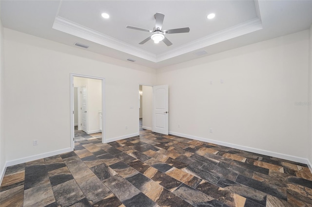 unfurnished bedroom with crown molding, a raised ceiling, and ceiling fan