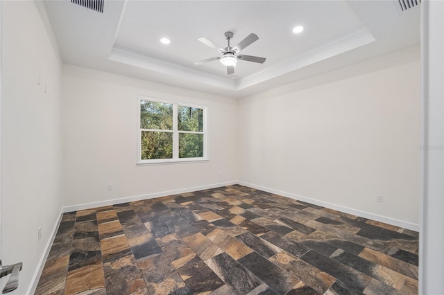 spare room with crown molding, ceiling fan, and a tray ceiling