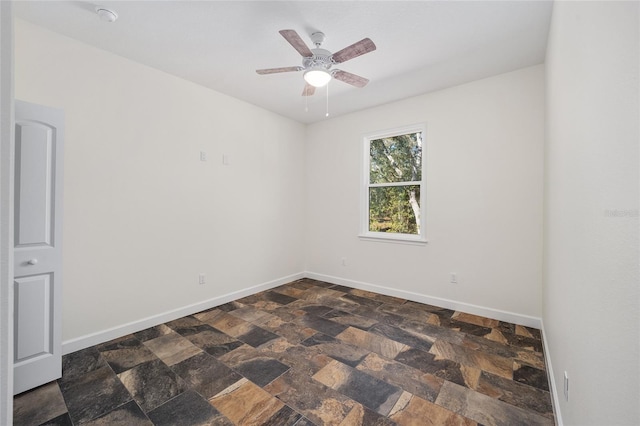 tiled spare room featuring ceiling fan