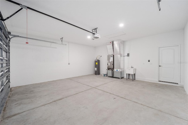 garage featuring heating unit, sink, electric water heater, and a garage door opener