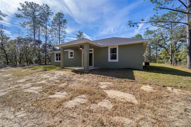 rear view of property with a lawn