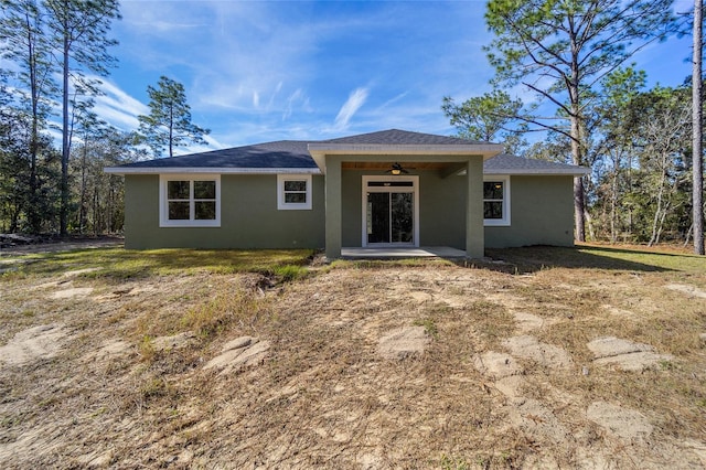 rear view of house with ceiling fan