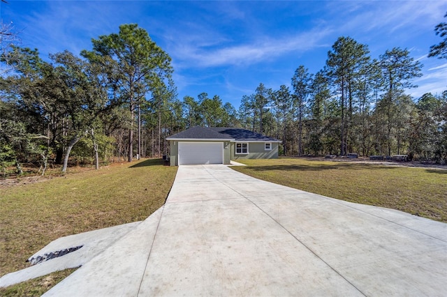 ranch-style home featuring a garage and a front lawn