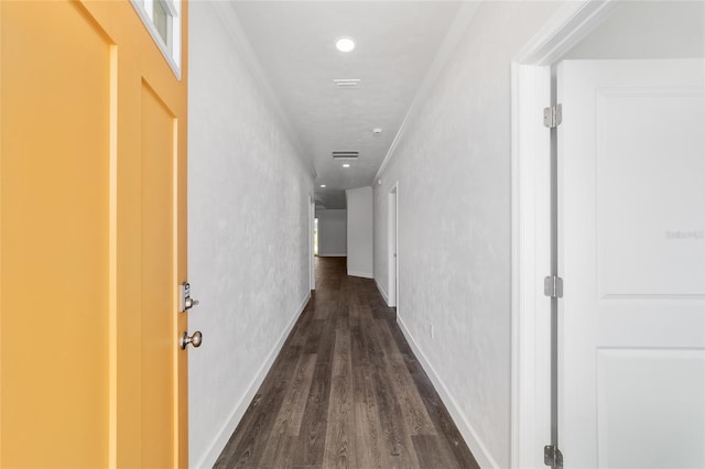 corridor featuring crown molding and dark hardwood / wood-style flooring