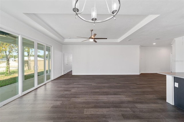 unfurnished living room featuring wood-type flooring, ceiling fan with notable chandelier, a raised ceiling, and crown molding