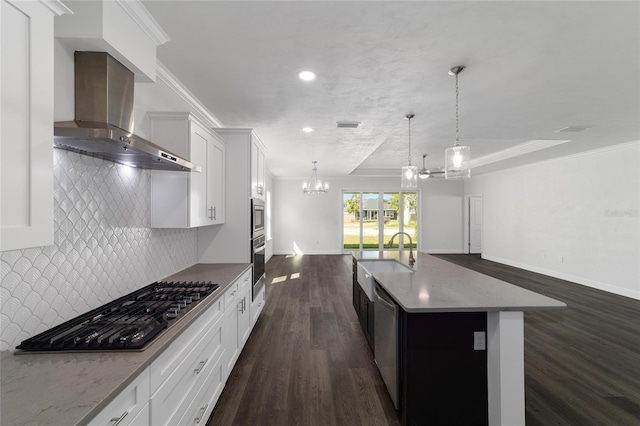 kitchen with a center island, dark wood-type flooring, wall chimney exhaust hood, decorative backsplash, and sink