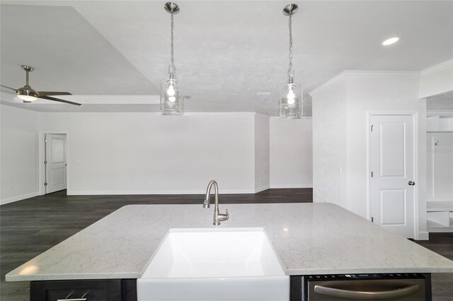 kitchen featuring a kitchen island with sink, hanging light fixtures, ornamental molding, and sink