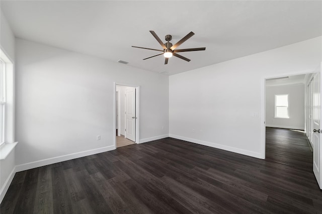 spare room featuring ceiling fan and dark hardwood / wood-style flooring