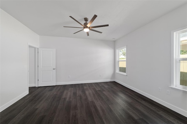 spare room featuring ceiling fan and dark hardwood / wood-style flooring