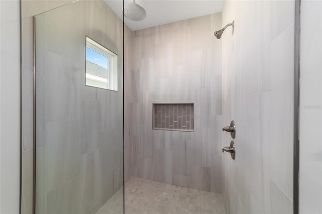 bathroom with tiled shower