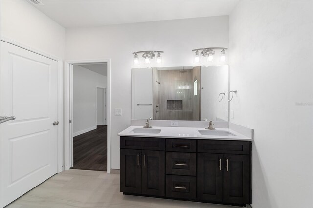 bathroom featuring hardwood / wood-style flooring and dual bowl vanity