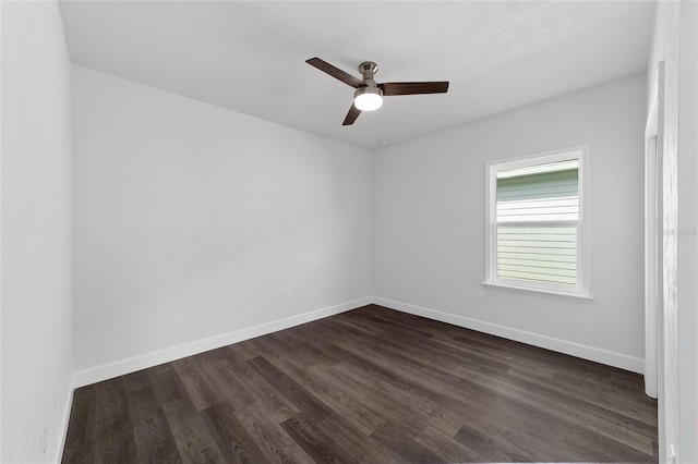 spare room featuring dark hardwood / wood-style flooring and ceiling fan