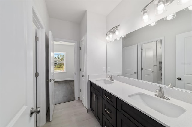 bathroom featuring double vanity and hardwood / wood-style flooring