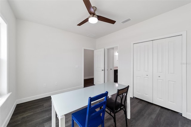 dining space with ceiling fan and dark hardwood / wood-style flooring