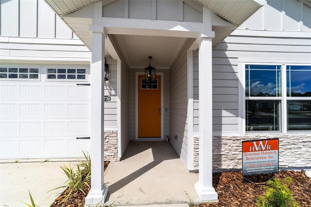 view of exterior entry with a garage