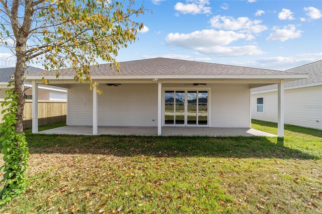 rear view of property with a patio area and a lawn