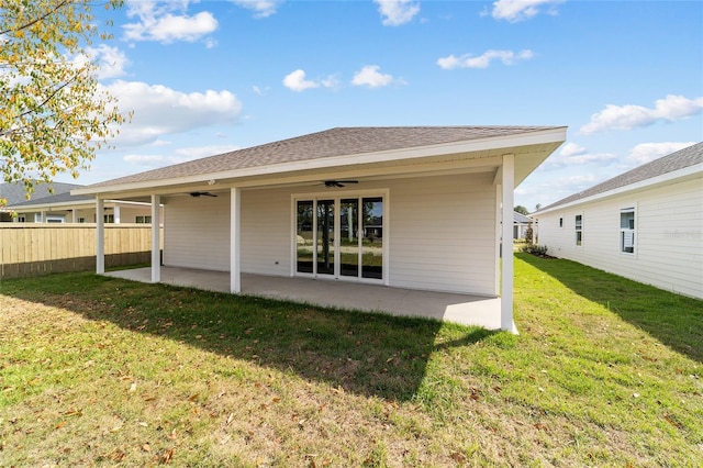 rear view of property featuring a yard, a patio area, and ceiling fan