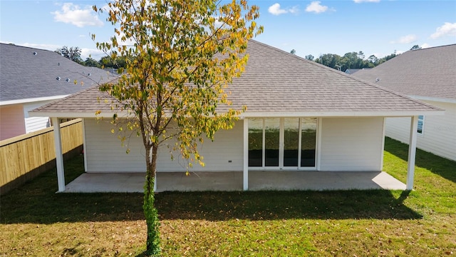 rear view of house featuring a patio and a yard