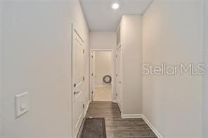 hallway featuring dark hardwood / wood-style flooring