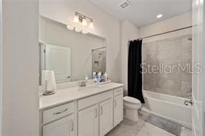 full bathroom with vanity, tile floors, shower / bath combo, and toilet