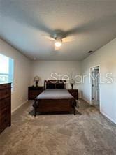 bedroom featuring light carpet and ceiling fan