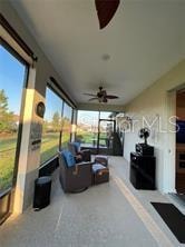 exterior space featuring an outdoor living space and ceiling fan