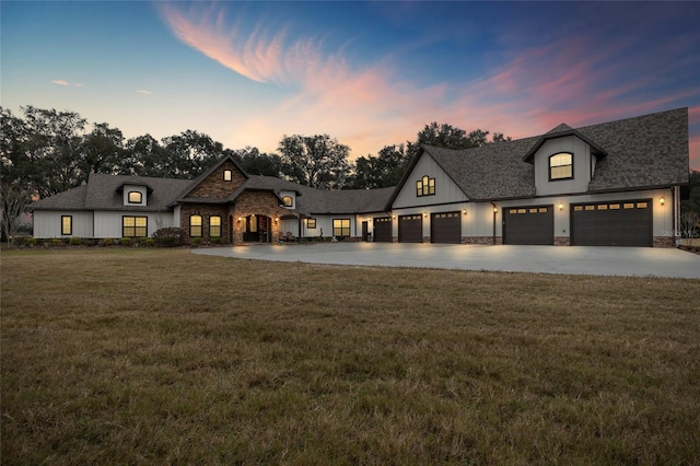 french provincial home featuring a yard and a garage