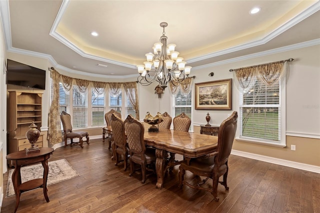 dining area with a chandelier, crown molding, a raised ceiling, and dark hardwood / wood-style flooring