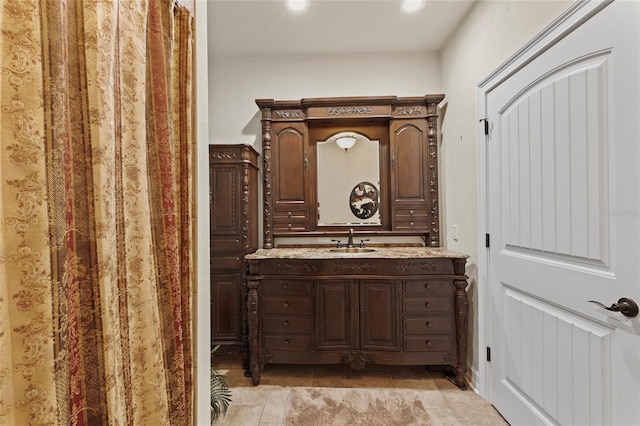 bathroom featuring tile floors and large vanity