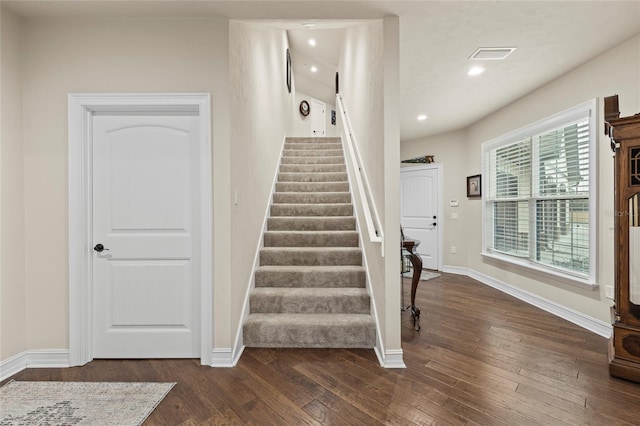 staircase with dark hardwood / wood-style flooring