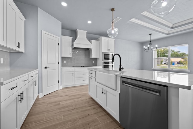 kitchen featuring custom range hood, ornamental molding, stainless steel appliances, and white cabinets